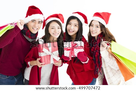 Happy young group  in santa hat and shopping together