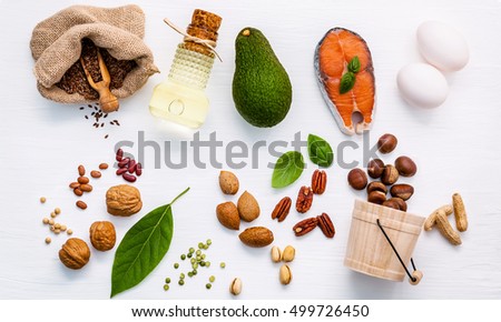 Selection food sources of omega 3. Super food high unsaturated fats for healthy food. Almond ,pecan ,hazelnuts,walnuts ,olive oils ,fish oils ,salmon ,flax seeds, peanut, eggs and avocado flat lay. Royalty-Free Stock Photo #499726450