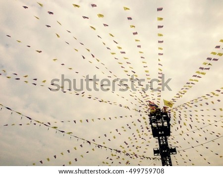 Thai Temple Roof with Thai flags and Wheel of Dhamma flags with sunlight