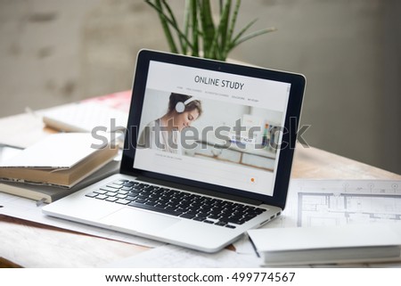 Open laptop on the desk with a title online study on the screen. Education concept photo