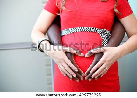 new expecting mom with husband holding belly
