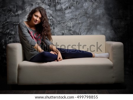 Portrait of young girl on sofa