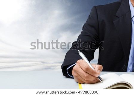 Concept of suited man writing schedule dairy book