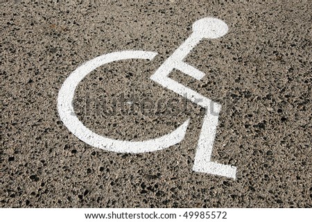 Disabled parking permit sign painted on the street