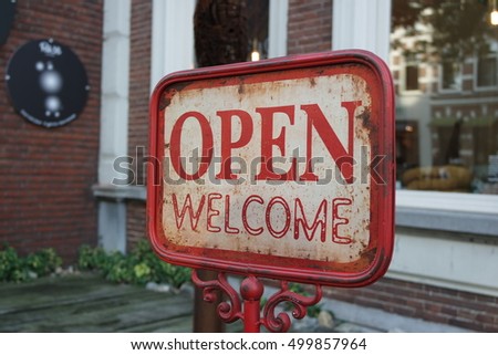 Open welcome red rusted sign