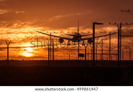 Silhouette of an airplane landing at the airport. Great concept about transportation