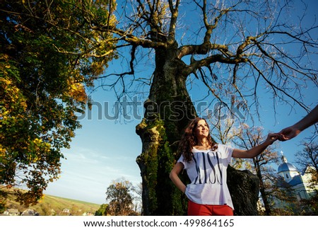 The charming bride near tree