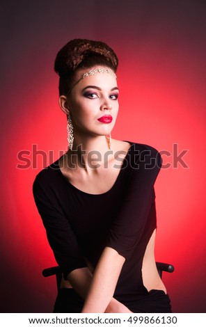 Girl fashion studio shot portrait in dress with hairstyle and jewelery