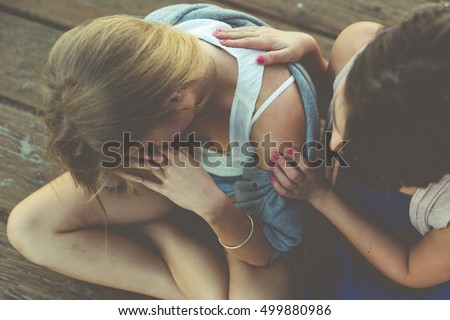 Desperate woman getting support from her best friend Royalty-Free Stock Photo #499880986