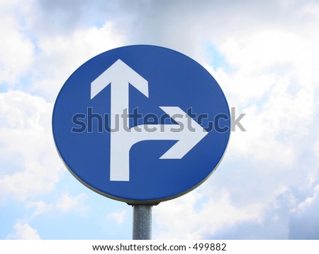direction sign against blue sky