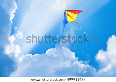 Kite flying in the sky among the clouds                       Royalty-Free Stock Photo #499916497