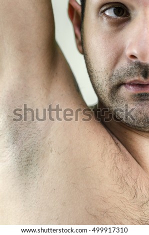 man shortens armpit hair