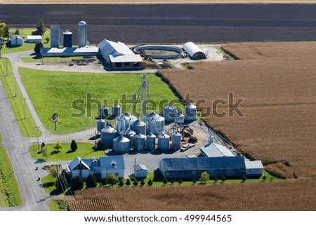 Autumn aerial view of a farm and fields at harvest season in rural Quebec, Canada.