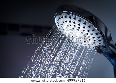 Image of a modern shower head splashing water close up background. Royalty-Free Stock Photo #499959316