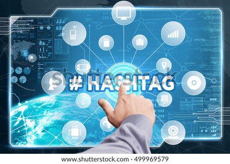 Business, Technology, Internet and network concept. Young businessman working on a virtual screen of the future and sees the inscription:#Hashtag