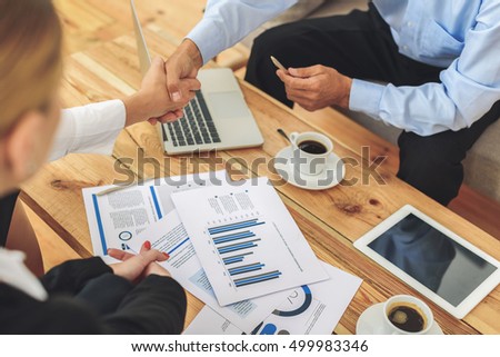Group of coworkers having discussion during meeting