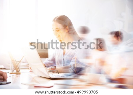 Double exposure of nice smiling girl working on laptop