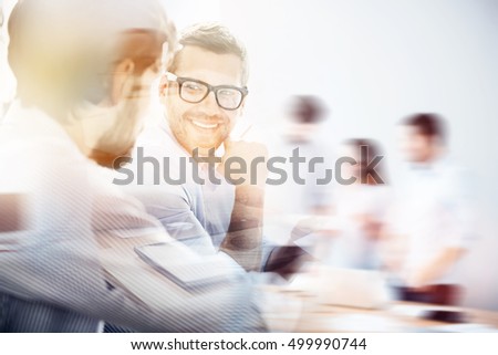 Smiling man during business meeting with his partner
