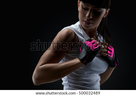 Close up portrait of fitness athletic young woman in sports clothing showing her well trained body