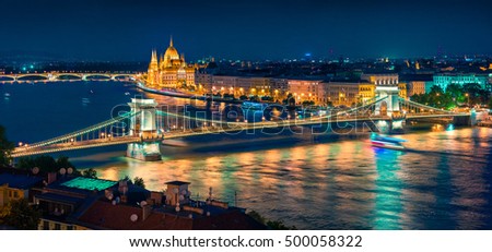 Night view of Parliament and Chain Bridge in Pest city. Colorful evening cityscape of Budapest, Hungary, Europe. Artistic style post processed photo.
