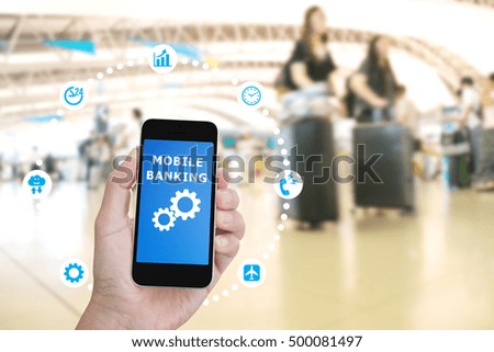 Hand holding mobile phone with Mobile banking application with blur crowd people background
