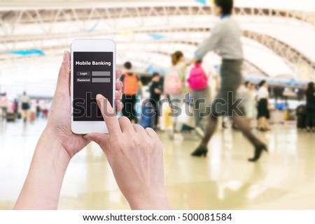 Hand holding mobile phone with Mobile banking application with blur crowd people background