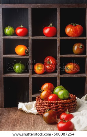 Colorful ripe tomatoes. Delicious vegetarian food. Dark background
