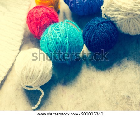 Colorful balls of wool on a wooden background/toned photo