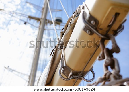 Blue sky and vintage 19th-century sailing ship mast, sunny background outdoors