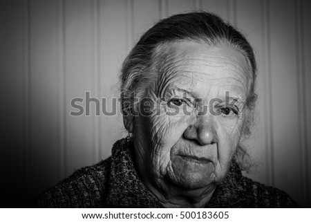 Portrait of an elderly woman on a light background. Toned.