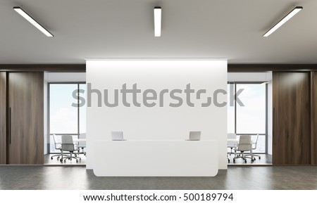 Reception table with two laptops and conference room with glass walls in the background. Concept of company office. 3d rendering. Mock up. Royalty-Free Stock Photo #500189794