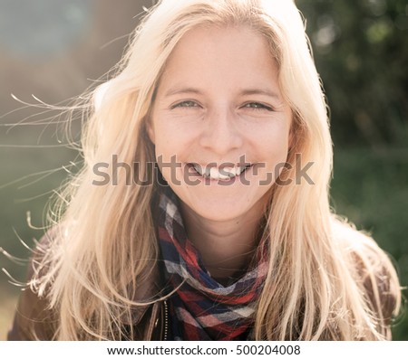 smiling, happy blonde woman outdoor portrait