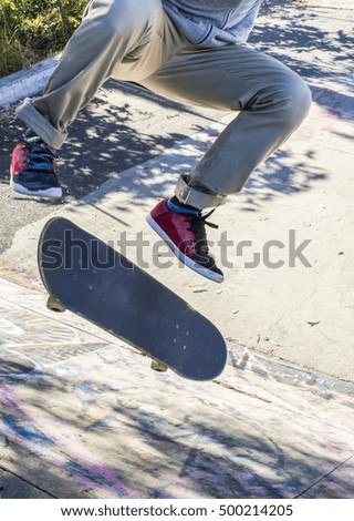 a guy running a kickflip skateboarding.