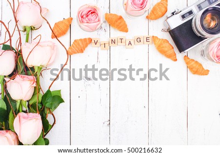 Travelling Concept with Vintage Camera on White Wooden Background and Pink Rose Bouquet, Flat Lay Style, Free Text Space