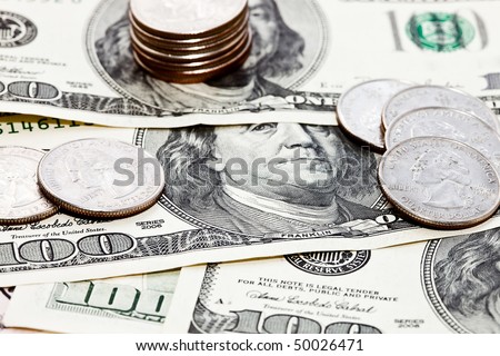 Closeup photo of coins over dollars background