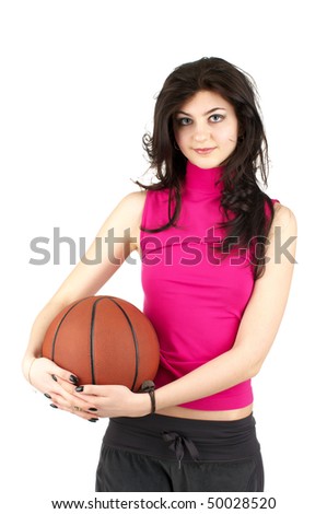 Cute young female in sports uniform holding the basketball