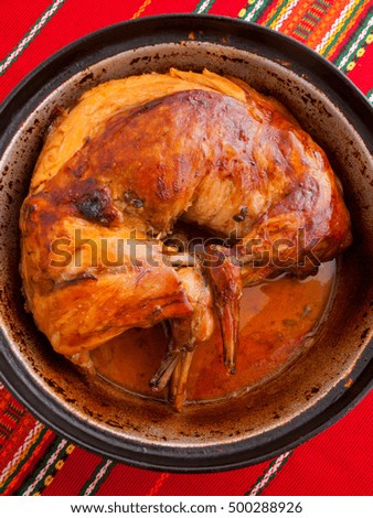 Whole baked rabbit in a casserole. Shot from above. Vertical shot