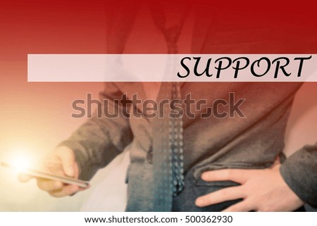 Hand writing support with the young business man on background. Business concept. Stock Photo.