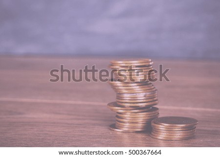 Stack of old penny coins on a wooden surface Vintage Retro Filter.