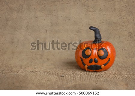 Halloween funny pumpkin face with vintage texture background