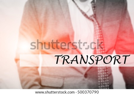 Hand writing TRANSPORT with the young business man on background. Business concept. Stock Photo.