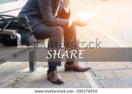 Hand writing SHARE with the young business man on background. Business concept. Stock Photo.