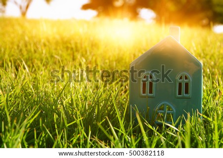 Image of vintage house in the grass, garden or park at sunset light