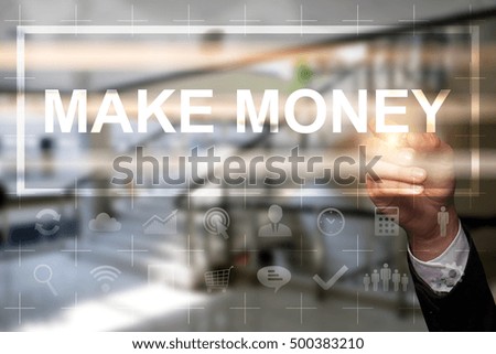 Businessman draws "Make Money" on the virtual screen. Business concept. Internet concept.