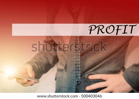 Hand writing PROFIT with the young business man on background. Business concept. Stock Photo.