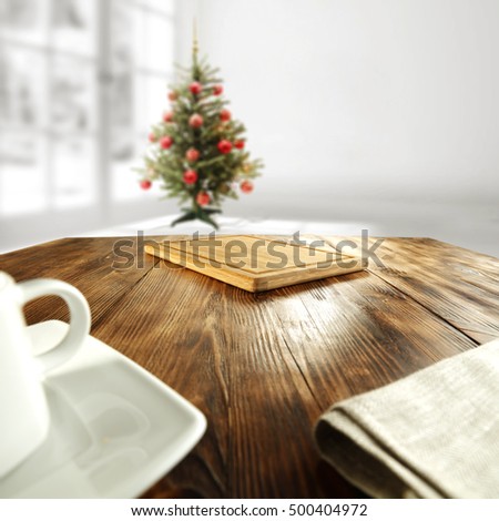 white interior with xmas tree and window with wooden brown table place 