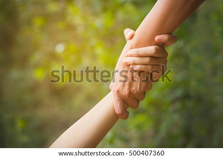 Helping hand outstretched for salvation . Strong hold. Royalty-Free Stock Photo #500407360