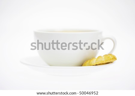 white cup and pastry isolated on white