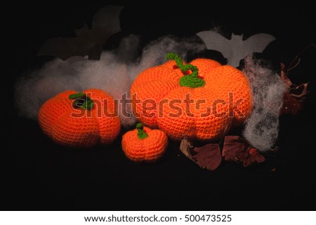 Knitted amigurumi pumpkins and bats on Halloween