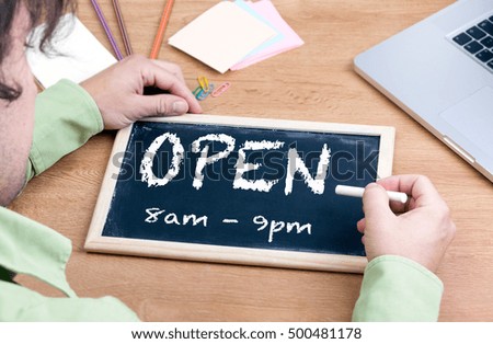 Open. Chalkboard on wooden office desk